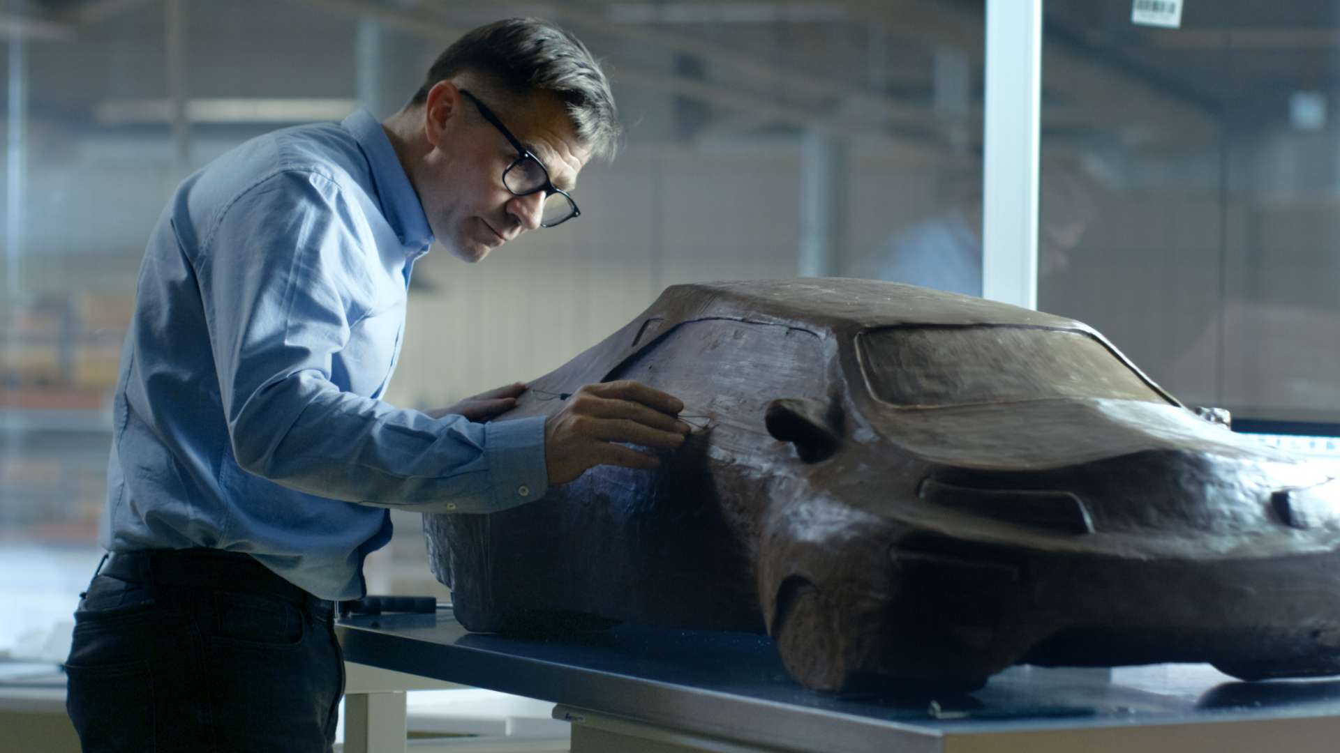 Technology – Tailored for you Man in a suit working on clay car