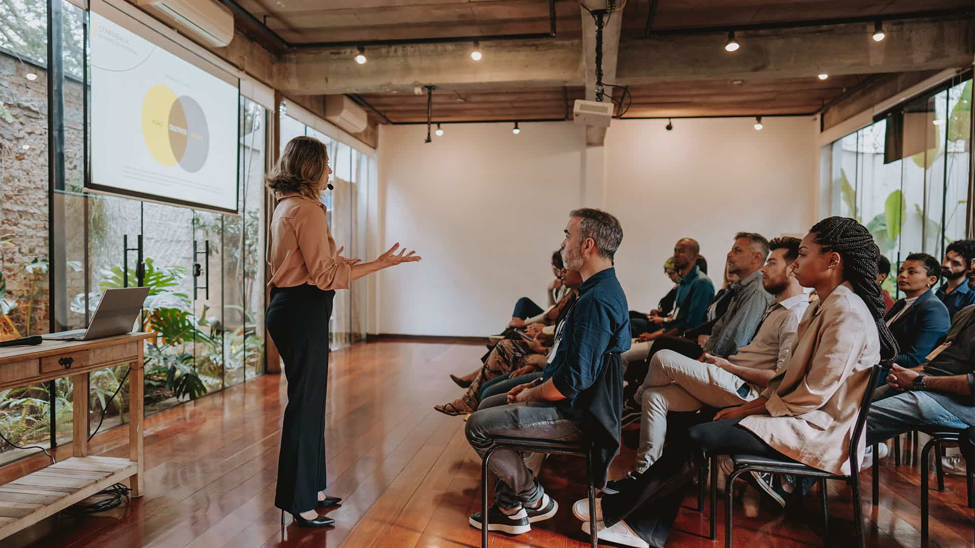 About us – driven by agility An individual presenting to a group of people