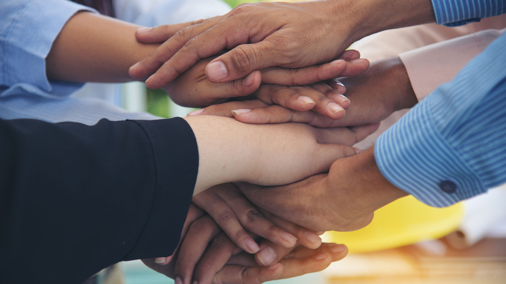 Sustainability – driven by ethics Hands all together in a pile