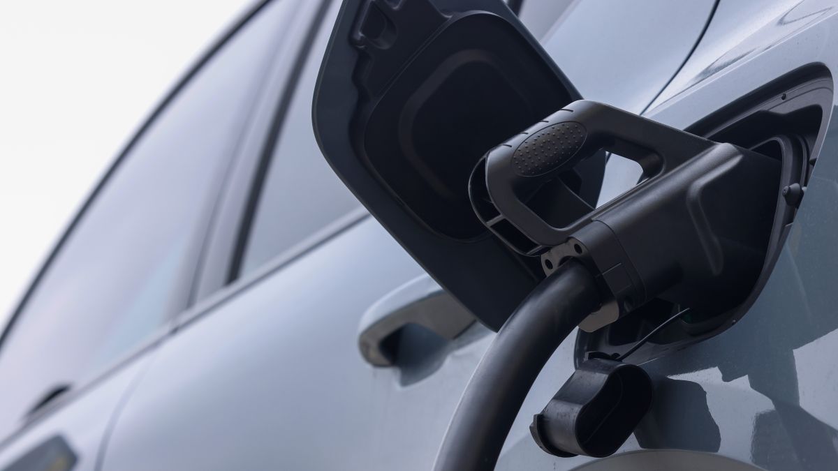 Charging gun plugged into the side of an EV Charging gun plugged into the side of an EV