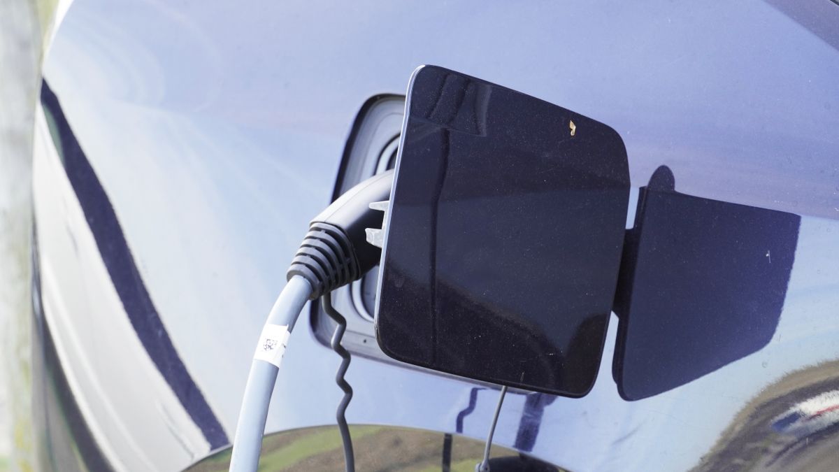 Charging port door Opened-up charging port door, with a charging gun plugged into the charging inlet of the electric vehicle