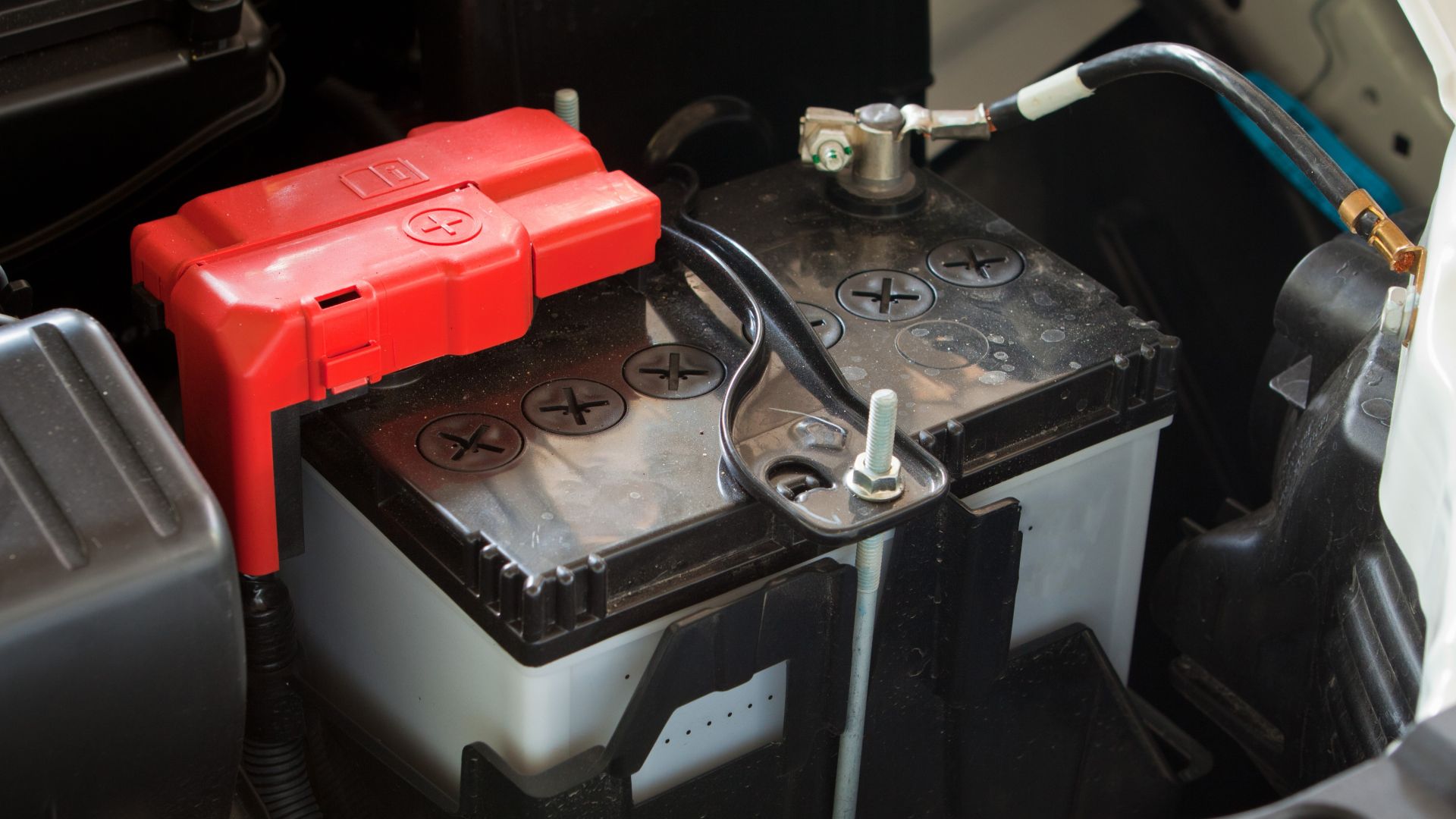 12V battery inside the engine bay of a vehicle